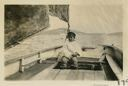 Image of Boy steering old fishing boat